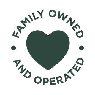 A dark green heart is centered with the words Family Owned and Operated written in a circular pattern around it, separated by two dots on a white background.