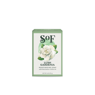 A green box of Lush Gardenia Moisturizing Bar Soap, with a white gardenia flower illustration. Highlights shea butter, olive oil, SLS-free formula. Net weight: 6 oz (170 g).